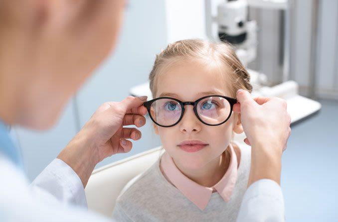 Young girl being fitted for new glasses