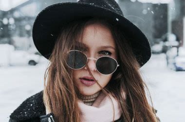 Woman in snow wearing UV coated sunglasses.