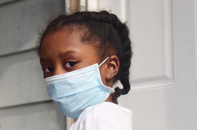 child wearing a mask with kawasaki disease
