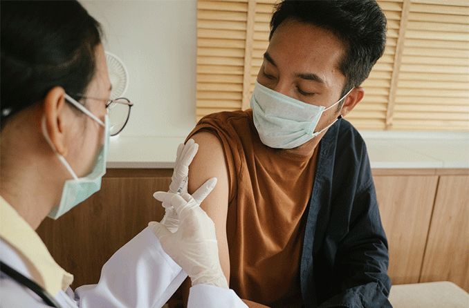 man getting the covid-19 vaccine shot