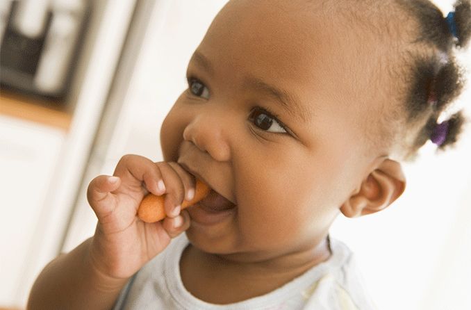 child eating a carrot