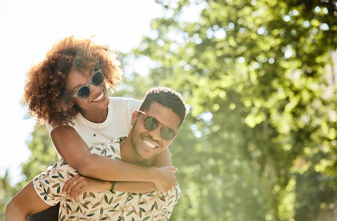 couple outdoors wearing Quay sunglasses
