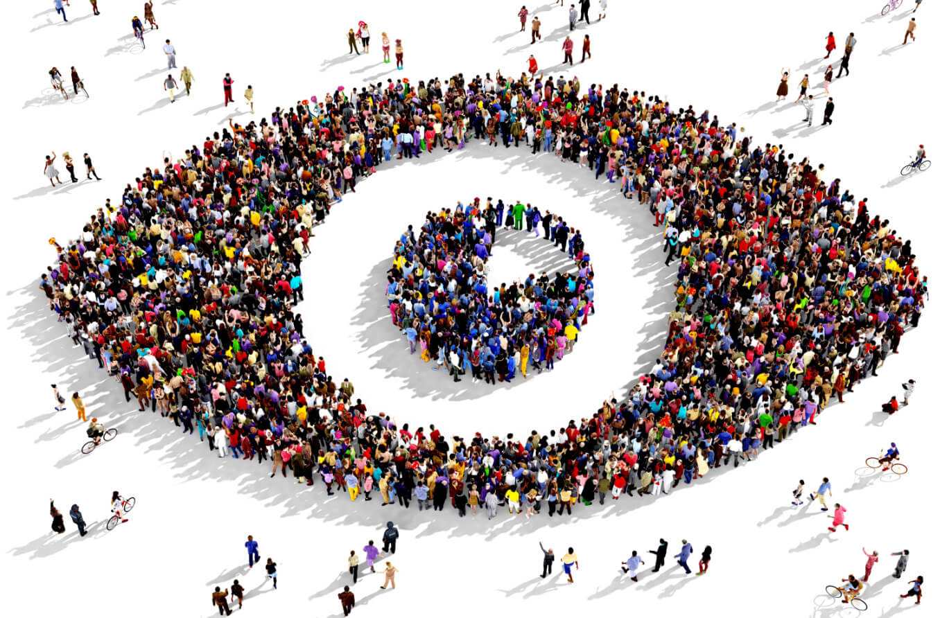 Large group of people seen from above gathered together in the shape of an eye.