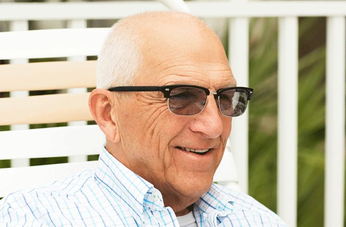 older man wearing transitions lenses