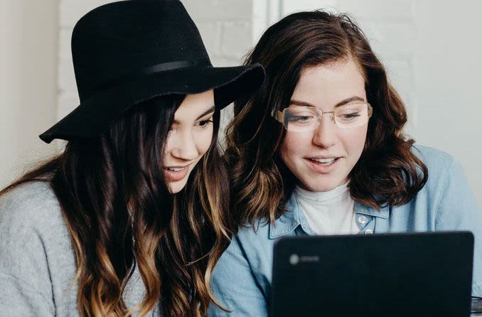Two girls shopping for glasses online