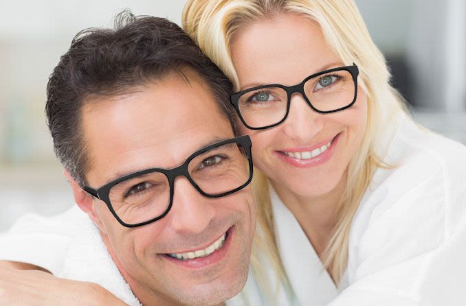 Couple wearing similar eyeglass frames