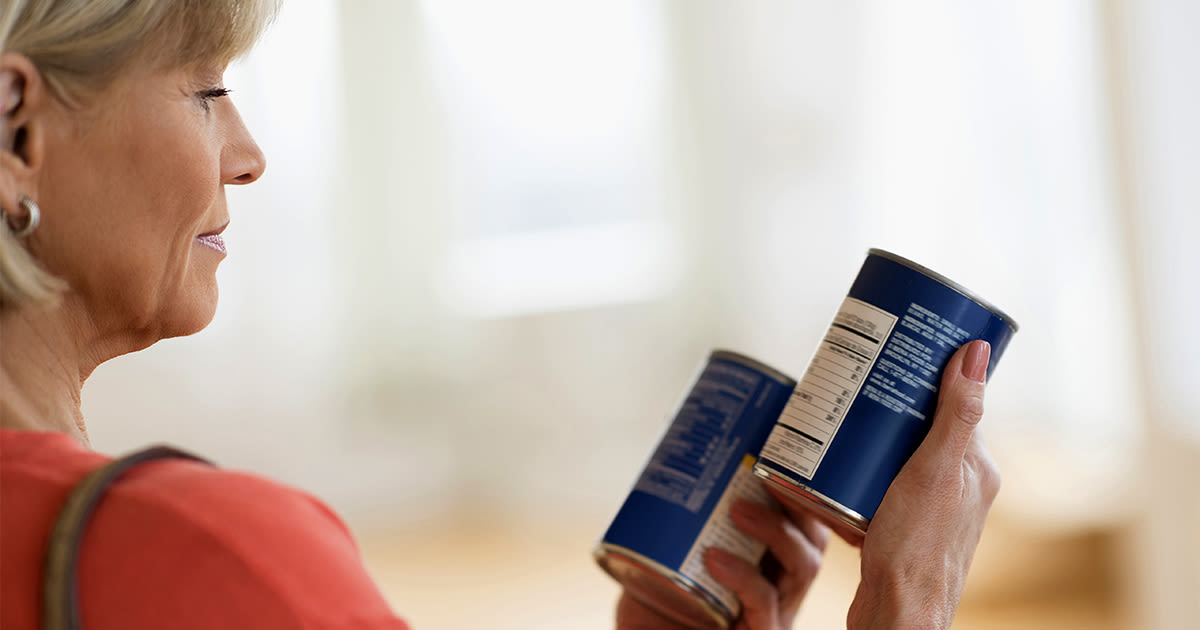 middle-age woman reading can labels without glasses