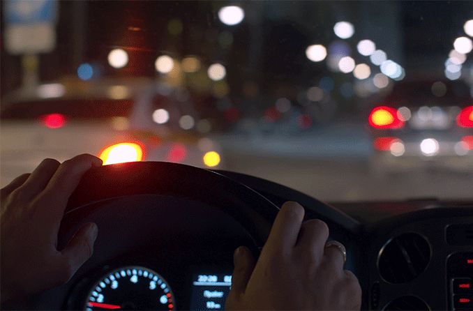 person with night myopia driving at night