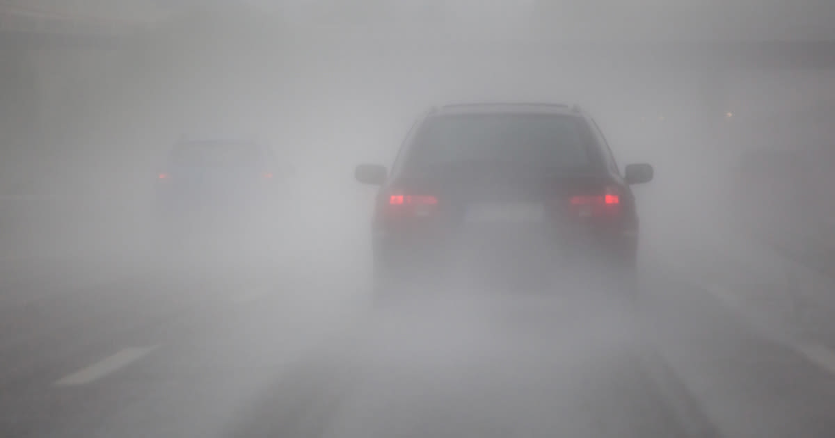 a car driving through dense fog
