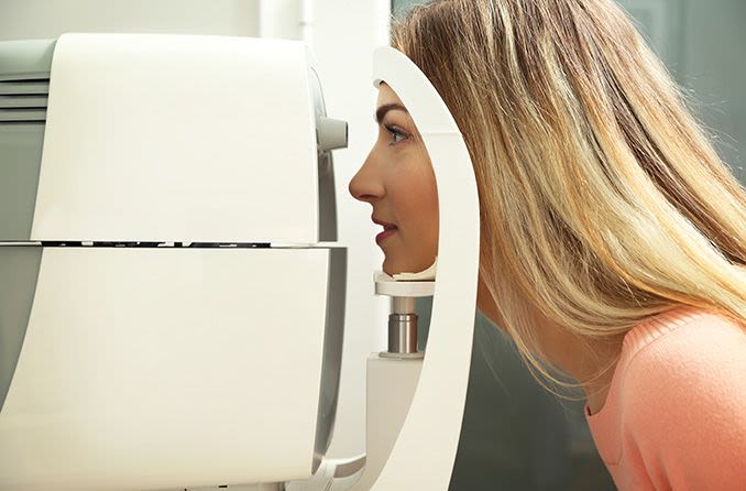 woman getting an eye pressure (intraocular) "air puff" test