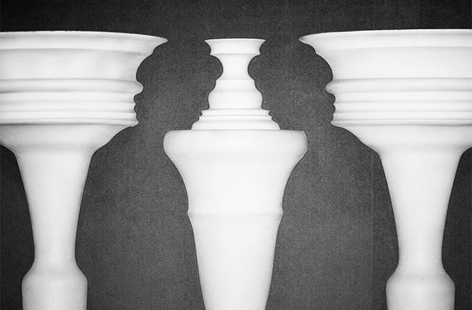 optical illusion of chess pieces that show the silhouette of two men