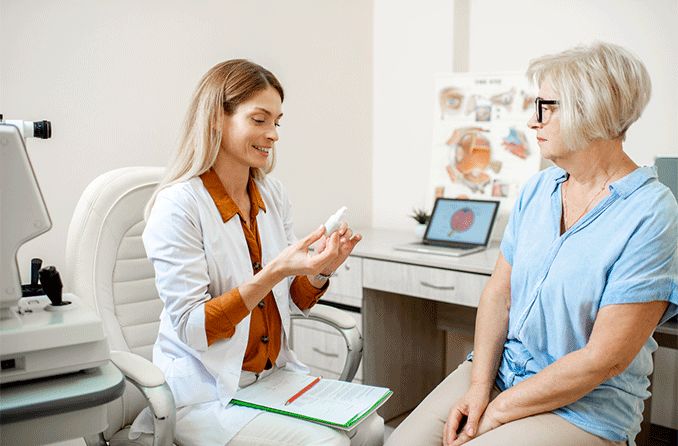 eye doctor performing dry eye test on patient holding numbing eye drops