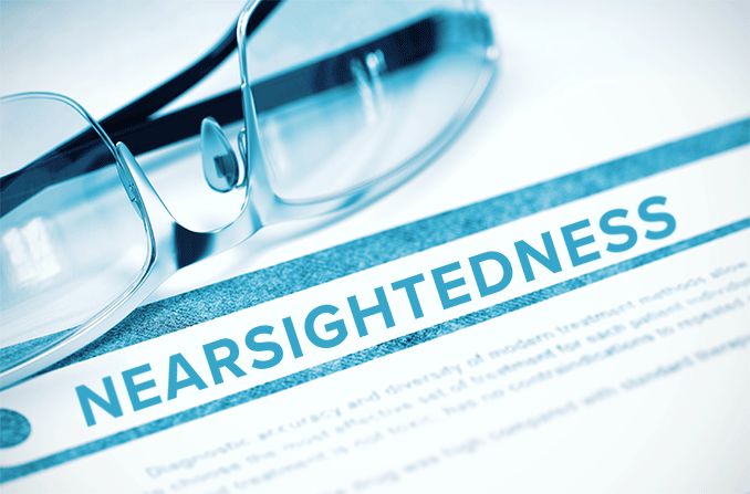 nearsightedness diagnosis written on paper next to pair of eyeglasses
