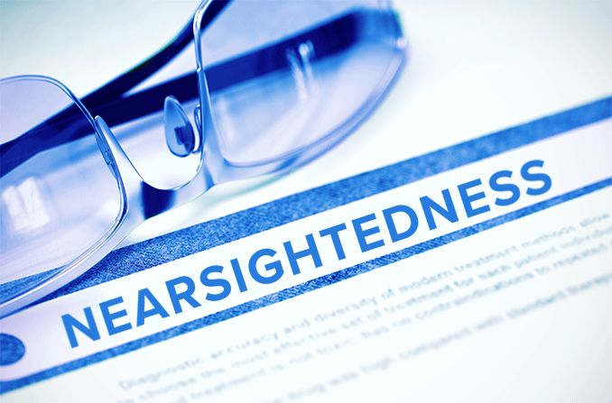 nearsightedness diagnosis written on paper next to pair of eyeglasses