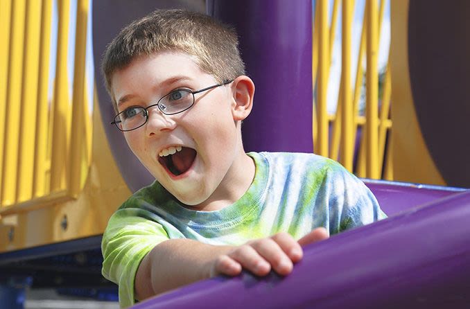 boy wearing polycarbonate lenses while riding a carnival ride