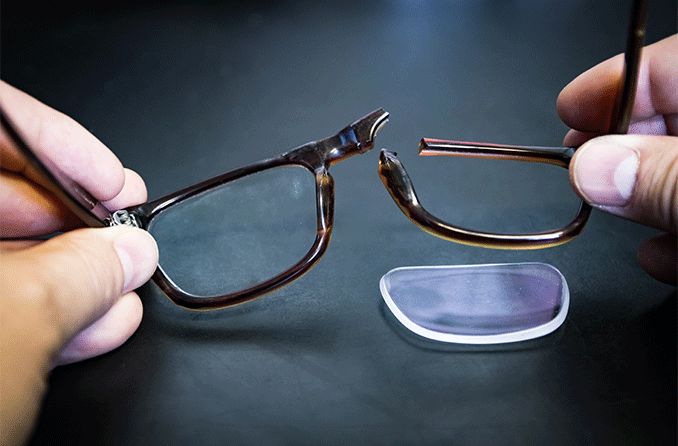 a pair of broken glasses with lens fallen out of frame