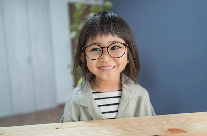 young girl wearing glasses with a lazy eye