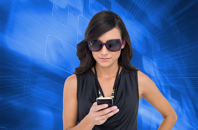 woman wearing sunglasses to protect her eyes from blue light on her mobile phone