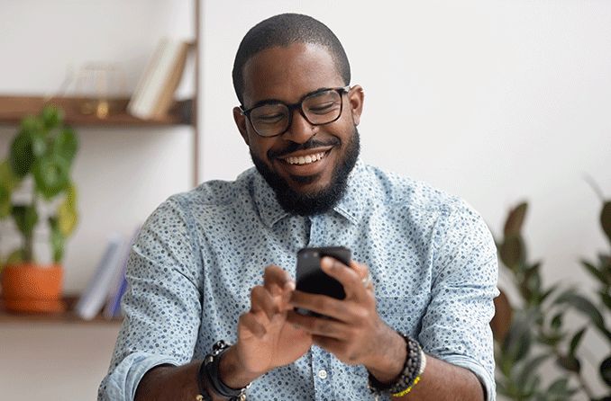 man shopping for contact lenses on his mobile phone through ContactsDirect