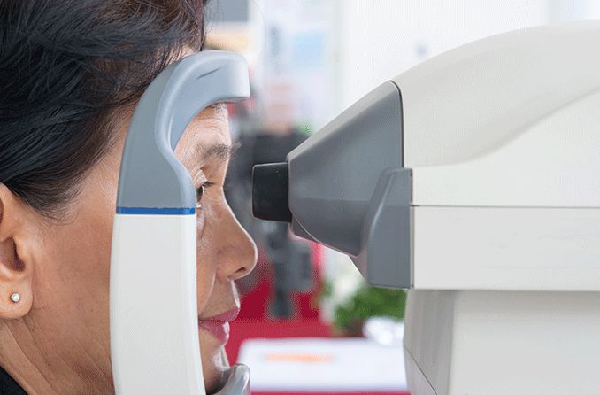 woman getting an eye exam checking her intraocular pressure