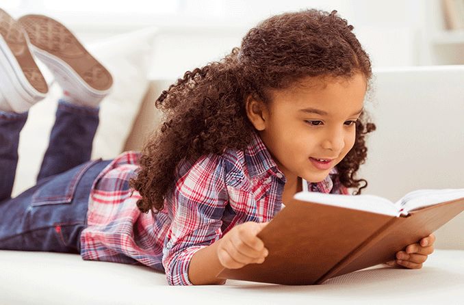 young girl reading a book experiencing convergence insufficiency