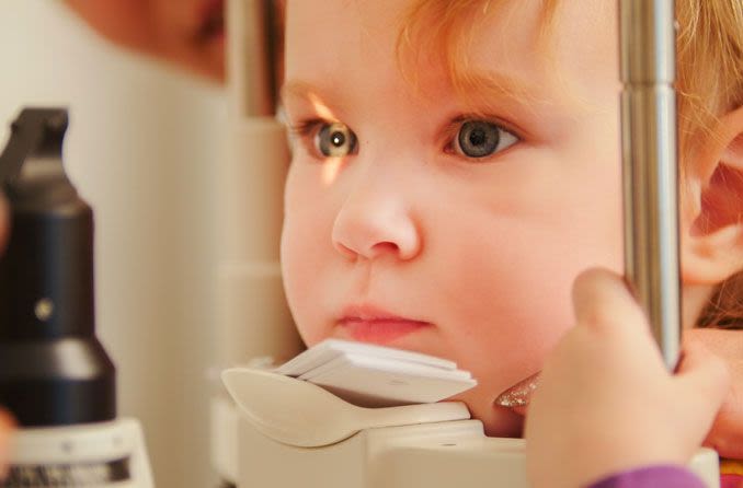 Child receiving myopia screening exam