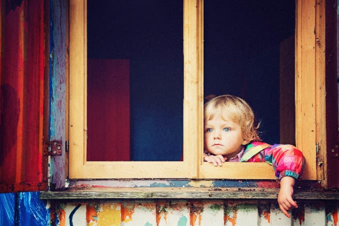 enfant regardant par la fenêtre