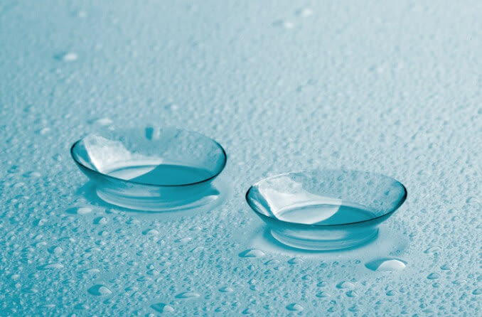 Pair of contact lenses on a wet surface