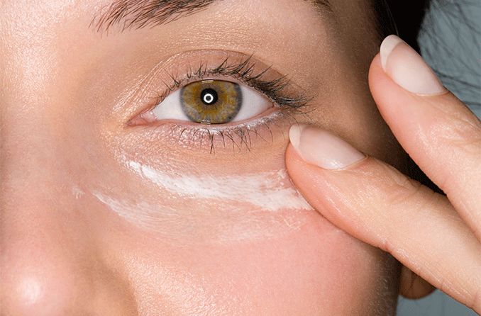 closeup of eye cream application under eye