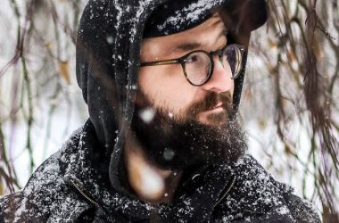 Man in snow wearing eyeglasses