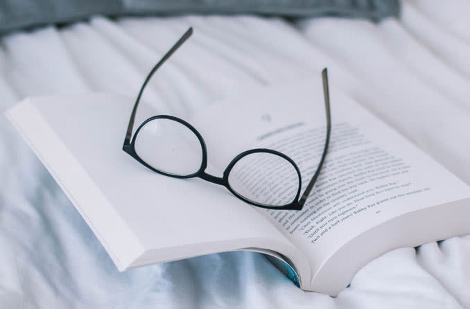 Hyperopia eyeglasses on top of a book