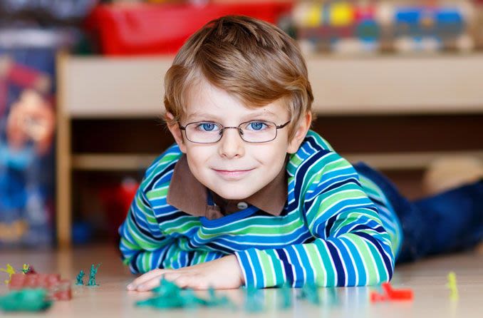 Young boy wearing glasses for myopia correction