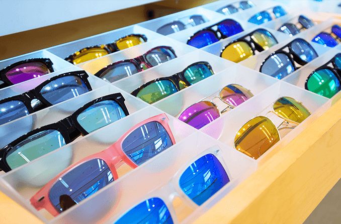 multiple sunglasses in a display case
