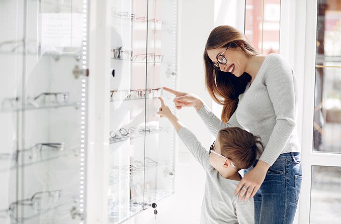 mother and son purchasing eyeglasses from an optical store