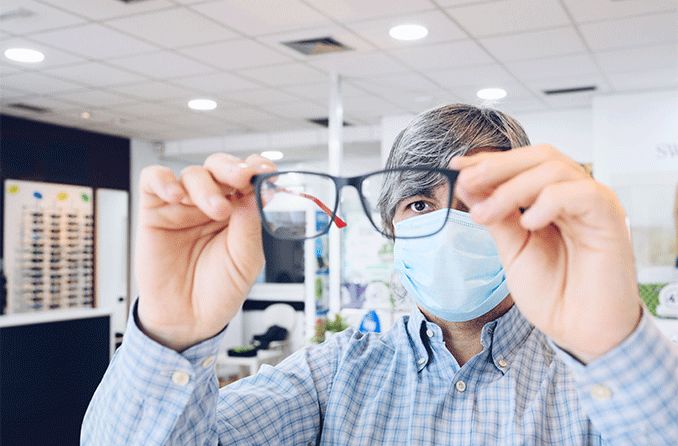 patient at eye doctor's office picking out eyeglasses during covid