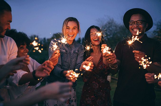 group of friends holding up sparklers to their faces