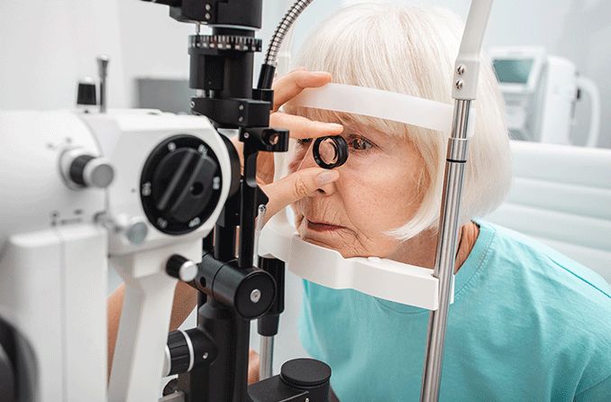 woman getting eye test with slit lamp to check retina and for optic nerve atrophy