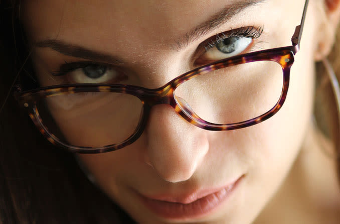 woman wearing spectacles looking up