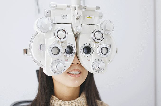 woman getting an eye exam checking for degenerative myopia