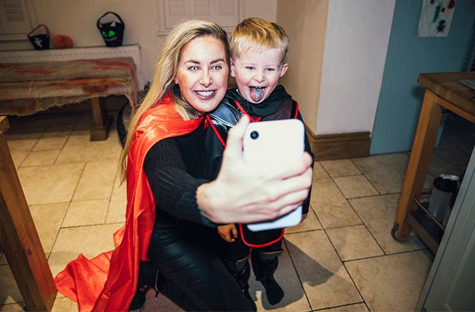 Mom wearing halloween contacts taking selfie with son