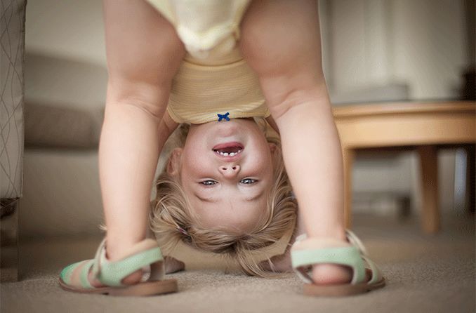 child looking upside down