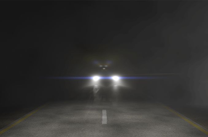 view of night blindness of a car's headlights on the road
