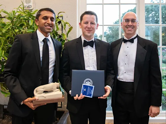 Dr. Ciaran Lane accepts certificates from fellowship program directors at fellowship graduation.