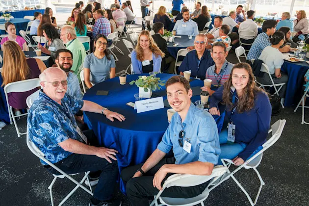 A group of people sitting around a table.