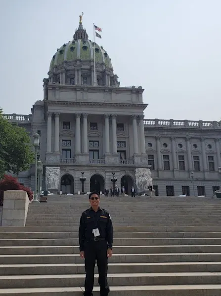 An EMS fellow stands in front of the Pennsylvania state Capitol building in Harrisburg