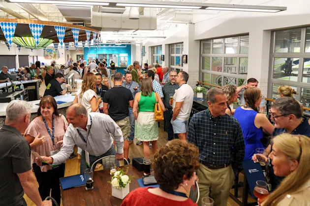 A group of people mingling at a restaurant.