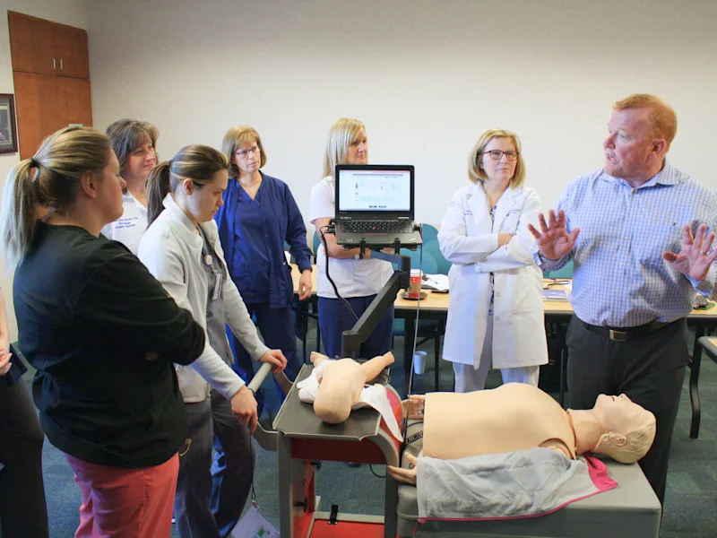Instructor demonstrates life support skills on manikin to a group of clinical learners at Penn State’s Simulation Center