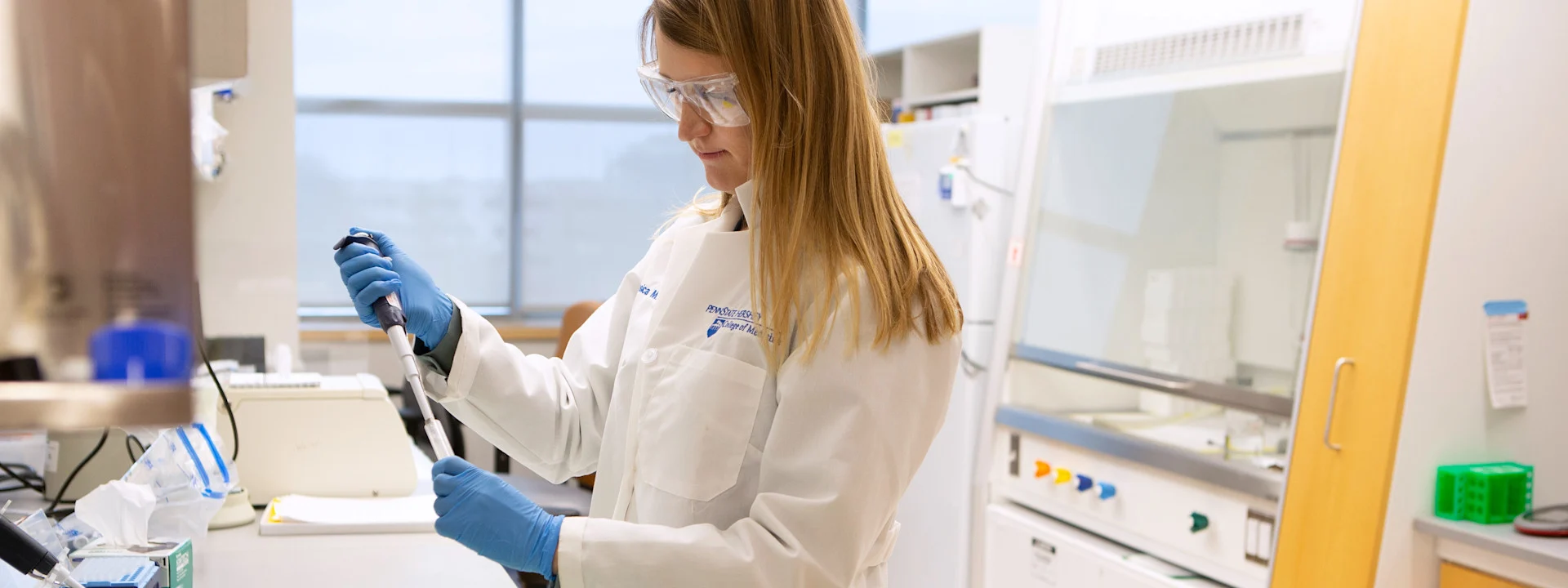 A scientists prepares a sample vial in a lab
