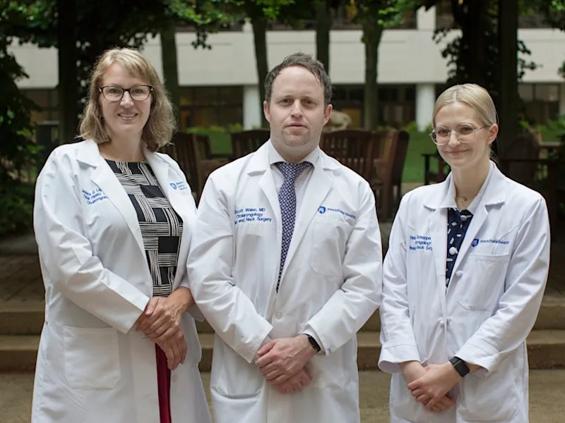 Three facial plastic surgeons posing for photo in white coats