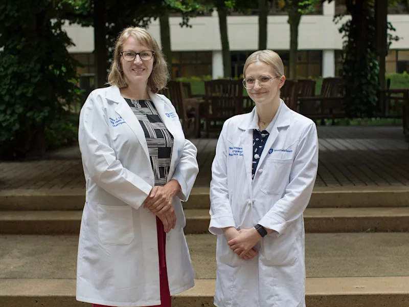 Two facial plastic surgeons posing for photo in white coats